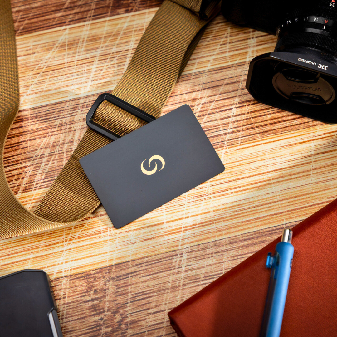 NFC Metal Cards with gold logo on a desk