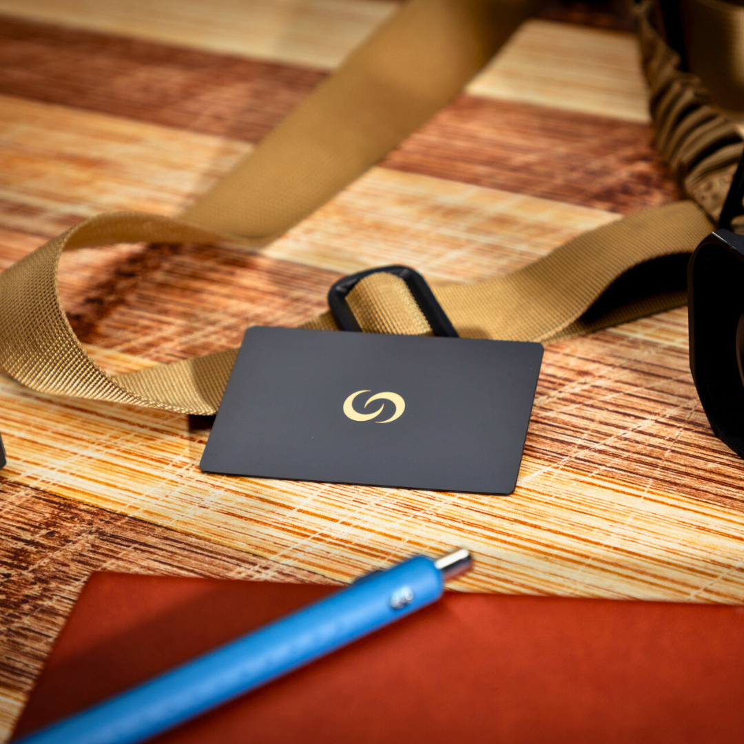 NFC Metal Card with gold Contact Co logo on a desk