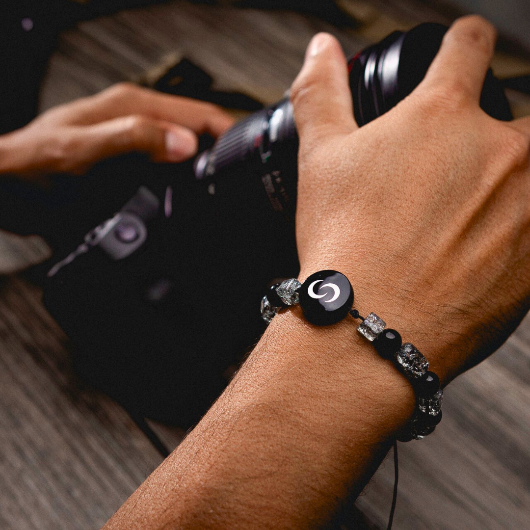 Black NFC Pendant on hand holding a camera