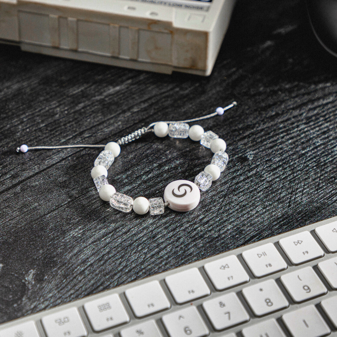White NFC Pendant on desk next to keyboard