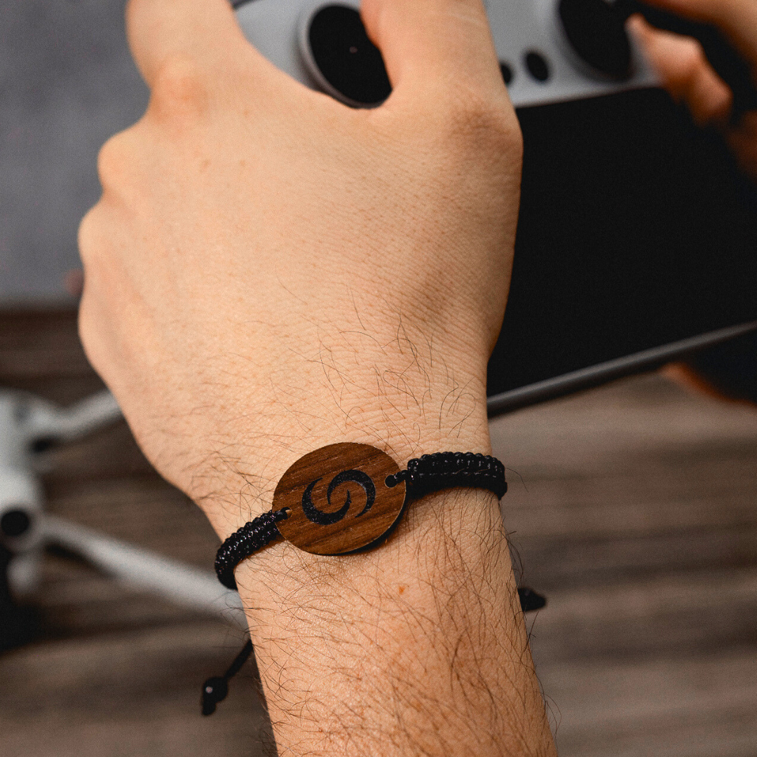 NFC Bracelet on hand, holding a drone controller